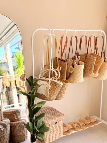 a mirror with baskets hanging on a wall at LAIWAII HOME in Hat Yai