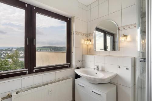 a bathroom with a sink and a window at Ferienwohnung Zum Hasen in Meschede