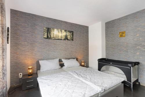 a bedroom with a large bed and a wall at Ferienwohnung Zum Hasen in Meschede