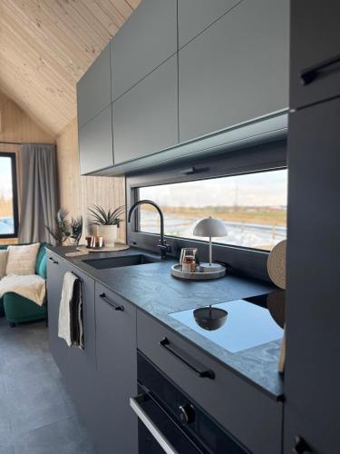 a kitchen with a sink and a counter top at Lieblingsplatz Parey - Tiny House in Parey