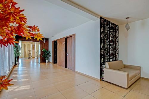 a living room with a couch and a hallway at Hotel O The Grand Imperial Restaurant & Hotel Dhuva Railway station in Morbi