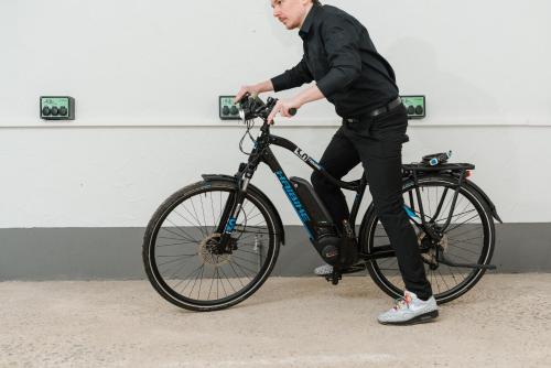 a man riding a bike against a wall at Coffee Fellows Hotel Trier in Trier