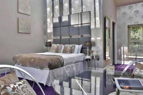 a bedroom with a bed and a glass table at Aston Hall Hotel, BW Signature Collection in Sheffield