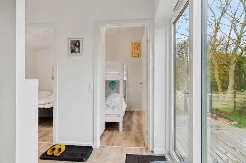 a room with a door leading to a room with a bedroom at Lovely Holiday Home Near The Limfjord in Thyholm