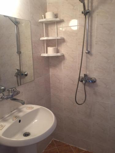 a bathroom with a white sink and a shower at Complex Laguna-Kantardzhiev in Primorsko
