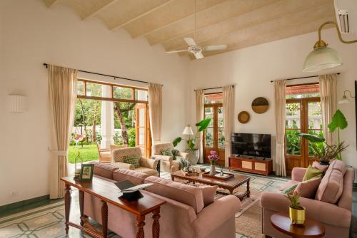 a living room with couches and a tv at La Selva - 4BHK Luxury Villa in Assagao with Private Pool near Cafés & Soro Pub in Assagao