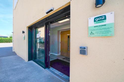 a door to a store with a sign on it at GO2 Gloucester Hotel by OYO in Gloucester