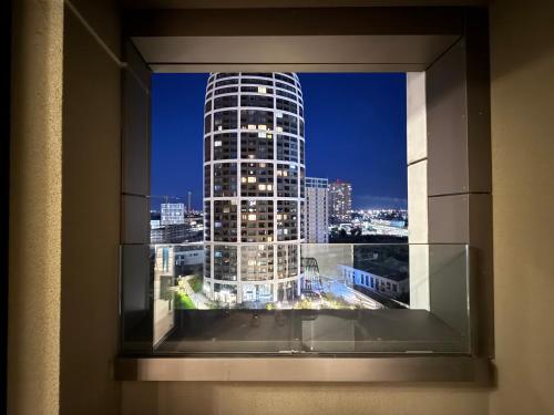 a view of a tall building from a window at Apartmán s výhľadom v centre, Downtown, Sky Park in Nivy