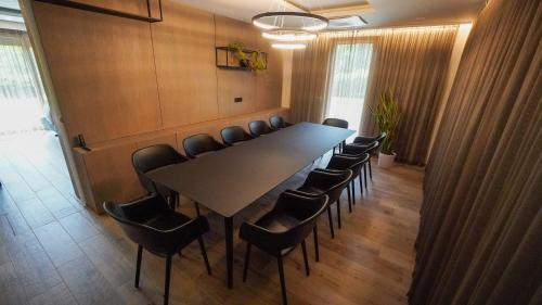 a conference room with a long table and chairs at Hiša na Hribu- A Peaceful Hilltop Escape above river Kolpa in Kostel