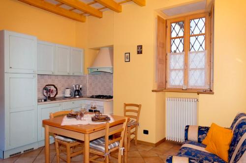 a kitchen and dining room with a table and a couch at Casa Aurora in Cannobio