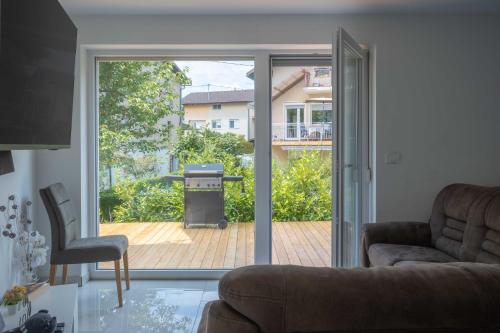 a living room with a sliding glass door to a patio at 4 Bedroom Private House On The Hill in Ljubljana
