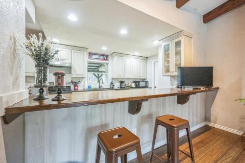 a kitchen with a counter with two stools at Hill Country Getaway Near San Marcos River home in San Marcos