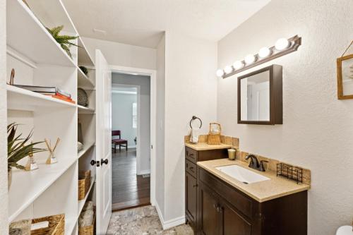 a bathroom with a sink and a mirror at Hill Country Getaway Near San Marcos River home in San Marcos