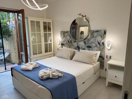 a bedroom with a large bed with towels on it at Villa Asia Relais in Massa Lubrense