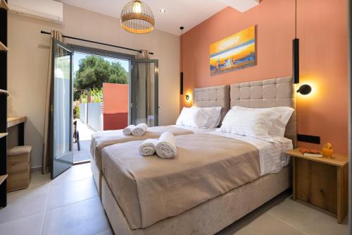 a bedroom with a large bed with towels on it at Olea Apartments in Razáta