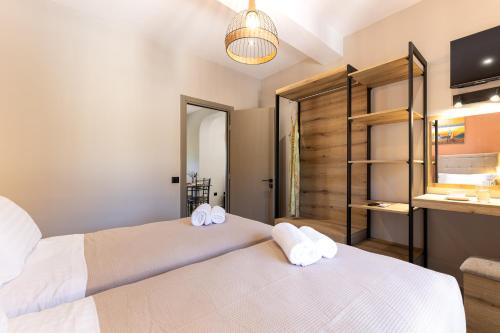 a bedroom with two beds with towels on them at Olea Apartments in Razáta