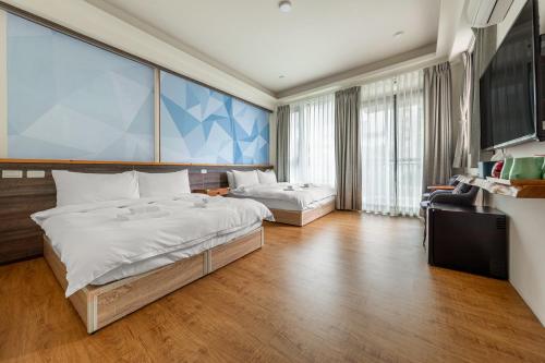 Una cama o camas en una habitación de 魚兒尖尖民宿