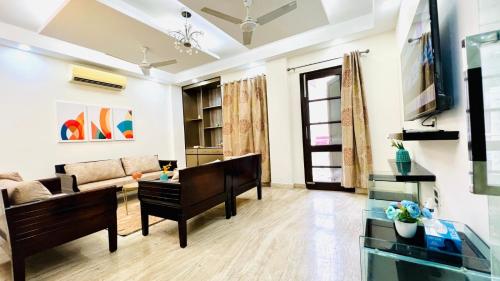 a living room with a couch and a table at Olive Service Apartments - Green Park in New Delhi