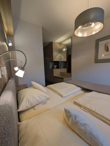 a room with three beds and a mirror at Weinhotel St. Stephanus in Zeltingen-Rachtig