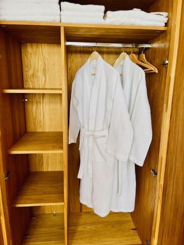 a closet filled with white robes and towels at Strunzova Pila - apartmány s wellness 2,06 a 3,03 in Kvilda