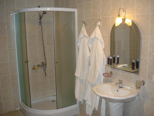 a bathroom with a shower and a sink at Жеруйык Отель in Aktau