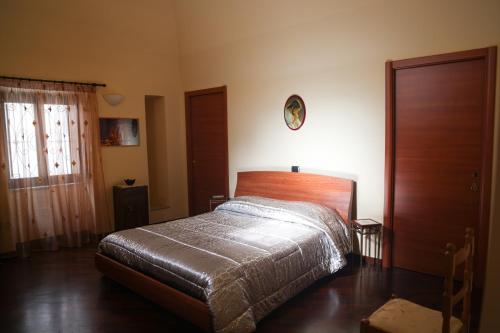 a bedroom with a bed and a clock on the wall at A CASA MIA in Giovinazzo