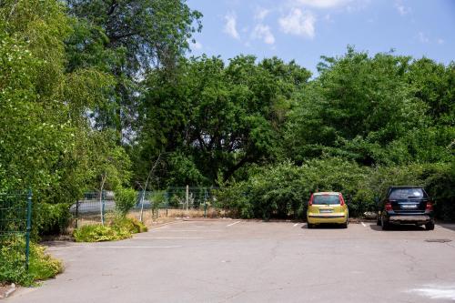 two cars parked in a parking lot with trees at Славна Кача in Odesa