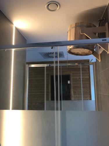 a mirror above a refrigerator in a kitchen at Strunzova Pila - apartmány s wellness 2,06 a 3,03 in Kvilda
