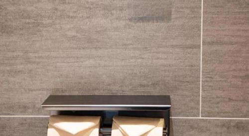 a black bench in a room with a wall at Atour Hotel Weihai Shidao in Dongshan