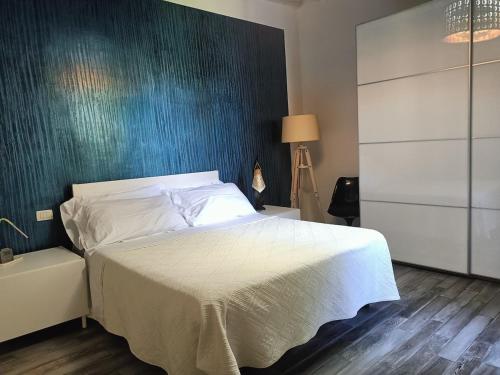 a bedroom with a bed and a blue wall at La Colonica - 3 people - 5 min from Florence in Bagno a Ripoli