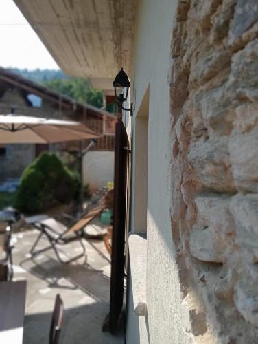 a light on the side of a stone wall at La Casa del Ghiro in Brirus