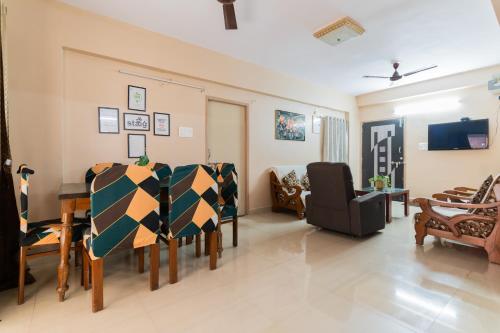 a living room with a table and chairs at Staeg Heart of the City 1BHK 601 in Bhopal