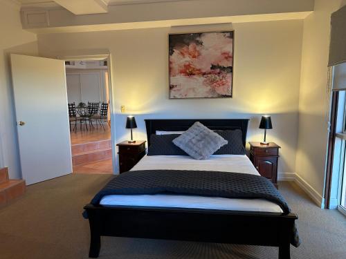 a bedroom with a large bed and two night stands at River Rock Retreat in Maroochy River