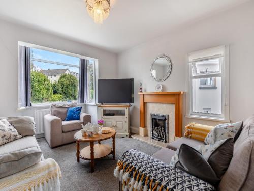 a living room with a couch and a fireplace at Leehaven in Torquay