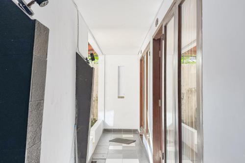 a hallway of a house with white walls at Villa Anugerah Linggarjati Mitra RedDoorz in Sangkanurip