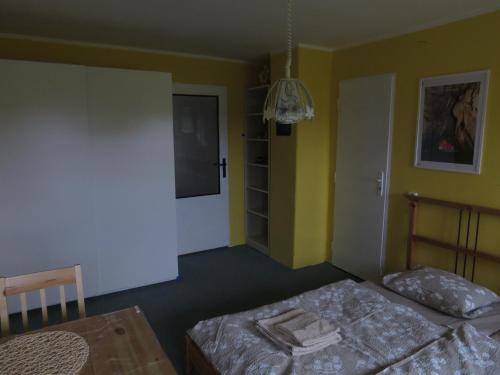 a bedroom with two beds and a table and a door at Apartment Nad Punkvou in Těchov