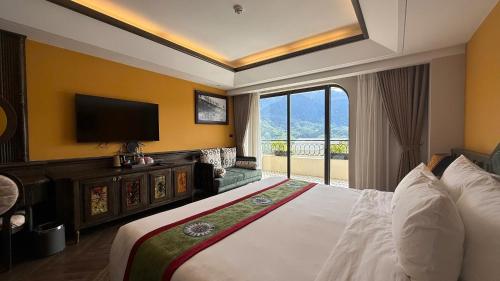 a hotel room with a bed and a flat screen tv at Fansipan View Hotel in Sa Pa
