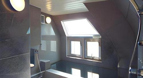 a bathroom with a window and a bath tub at Hotel Annex Check In Shimbashi in Tokyo