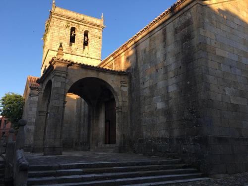 an entrance to a brick building with a tower at Hostal La Balsá in La Alberca