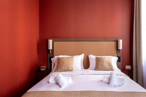 a bedroom with a bed with white sheets and pillows at Sol hotel St Mande - 4 personnes - 11 in Saint-Mandé