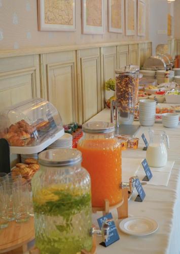 a table topped with jars of food and drinks at Nykščio Namai & SPA in Anykščiai
