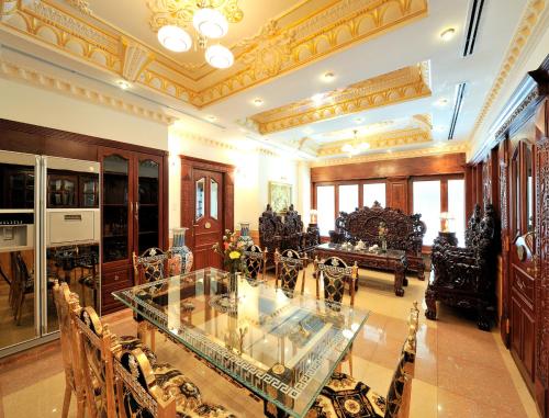 a large room with a glass table and chairs at New Pacific Hotel in Ho Chi Minh City