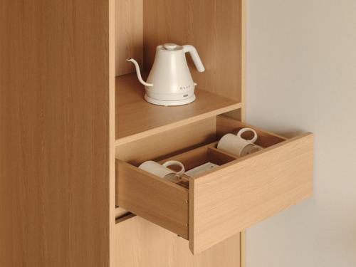 a wooden cupboard with a tea kettle in it at Urbanstay Hotel Dongtan in Hwaseong