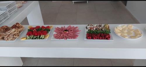 a white table with different types of food on it at Avka Palace in Edirne