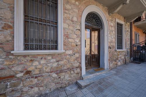 a brick building with a door and a window at Casa Di Rosella in Gavorrano