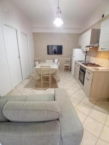 a kitchen and living room with a couch and a table at SA HOUSE in Barletta