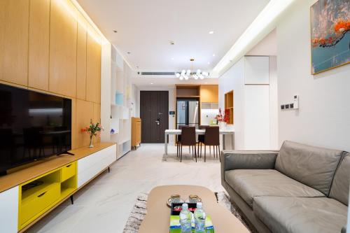 a living room with a couch and a tv at Convinia Luxury The Peak Midtown -Free Airport Pick Up in Ho Chi Minh City
