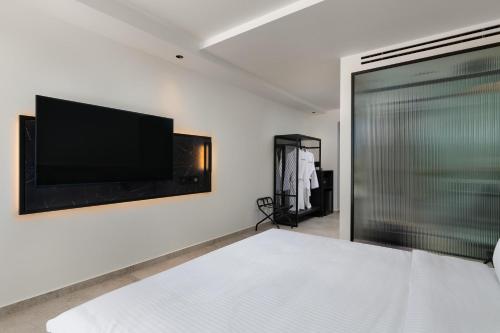 a bedroom with a flat screen tv on the wall at Agkyra Hotel in Rhodes Town