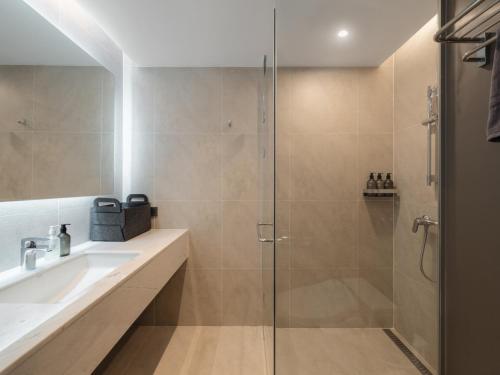 a bathroom with a shower and a sink at Urbanstay Hotel Dongtan in Hwaseong