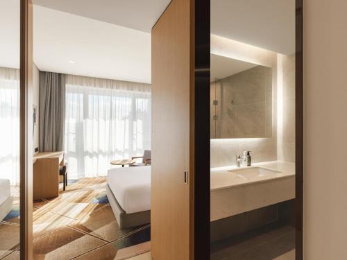 a hotel room with a bed and a bathroom at Urbanstay Hotel Dongtan in Hwaseong